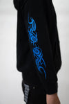 Close up on sleeve design that is glitter print, black zip up la familia hoodie