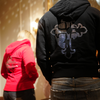Models wearing Black and Red LaFamilia zip up hoodie showing cross and skull rhinestone design on the back of the hoodie